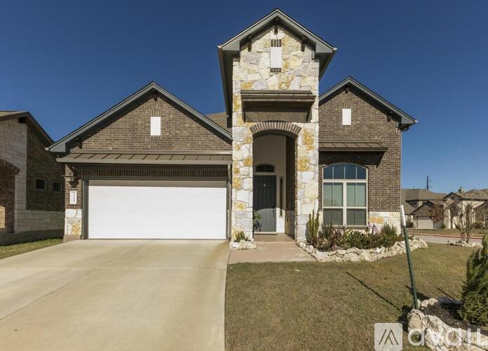A house with a stone pillar entrance and a garage door.