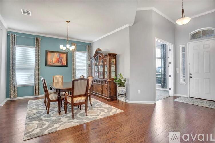 A dining room with a wooden table and chairs.