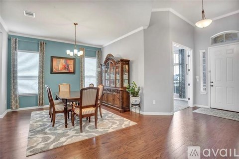 A dining room with a wooden table and chairs.