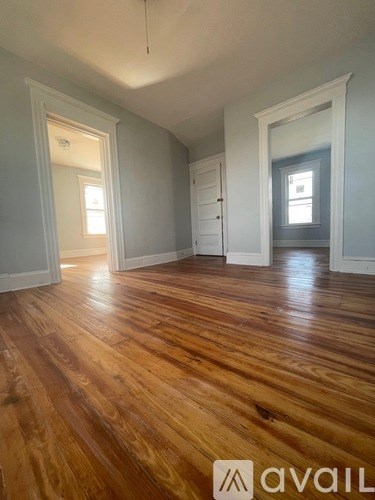 A room with wooden floors and white walls.