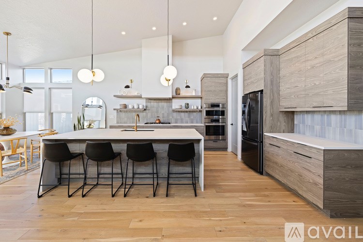 A modern kitchen with a dining table and chairs.