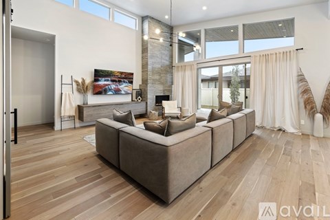 A modern living room with a large sectional sofa and a fireplace.