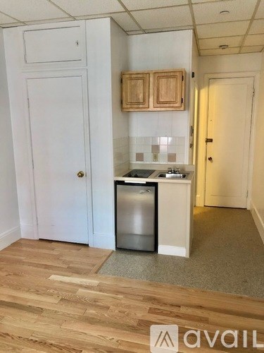 A small kitchen with a dishwasher and a refrigerator.