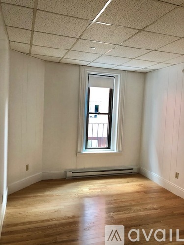 A room with wooden floors and a window.