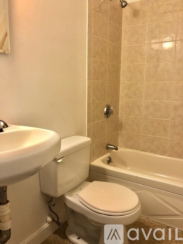 A bathroom with a toilet, sink, and bathtub.