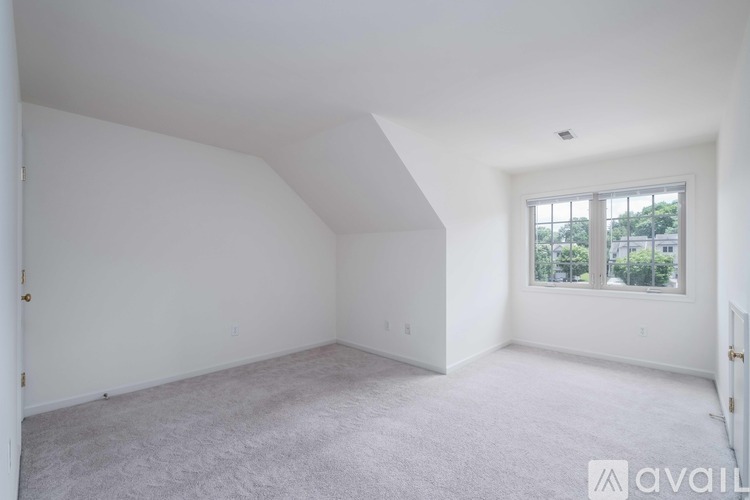 A spacious room with a window overlooking a street.