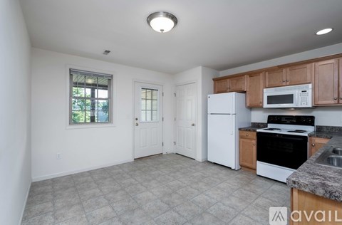 A spacious room with a window overlooking a street.