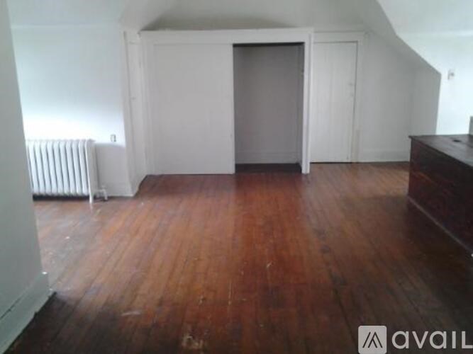 A room with wooden floors and white walls.