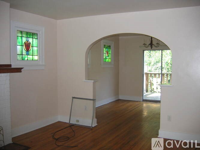 A room with a fireplace and a chandelier.