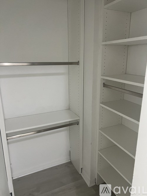 Empty white shelves in a storage unit.