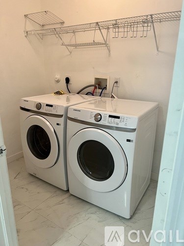 Two front loading washing machines in a laundry room.