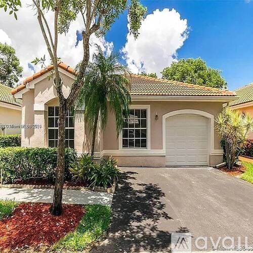 A kitchen with a counter, sink, and chairs.