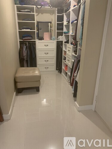 A white closet with drawers and shelves.
