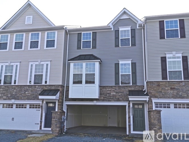 A two-story house with a garage is available for rent.