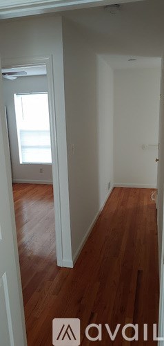 A room with wooden floors and white walls.