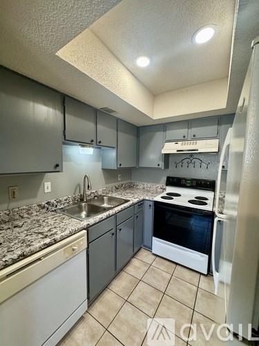 A kitchen with granite countertops and stainless steel appliances.