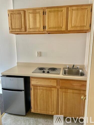 A kitchen with wooden cabinets and a white countertop.