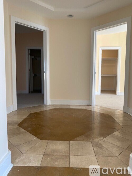 A room with a brown floor and white walls.
