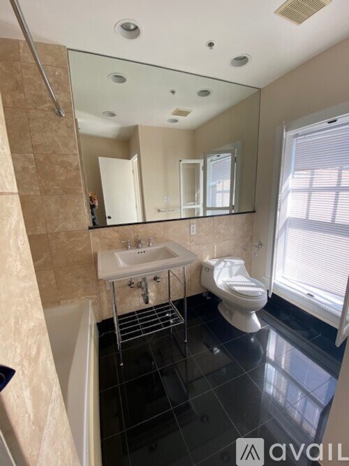 A bathroom with a sink, toilet, and bathtub.