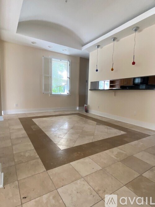 A room with a tiled floor and a window.