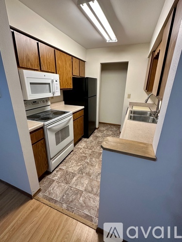 A kitchen with a stove, oven, refrigerator and microwave.