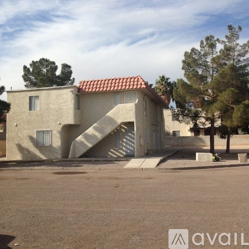 A house with a red tile roof and a staircase leading to the entrance.