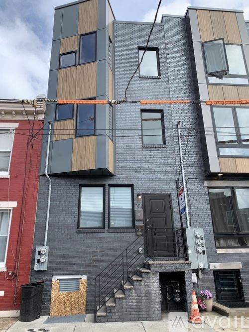 A modern multi-story building with a mix of brick and panel exterior.