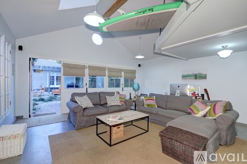 A living room with a grey couch and a coffee table.