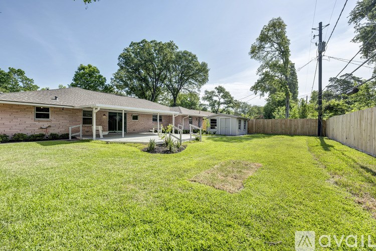 A house with a yard and a fence is for sale.