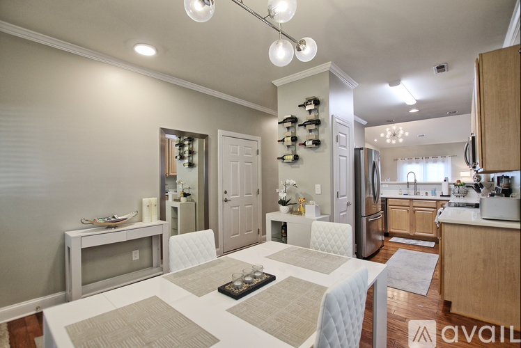 A kitchen with a white table and a refrigerator.
