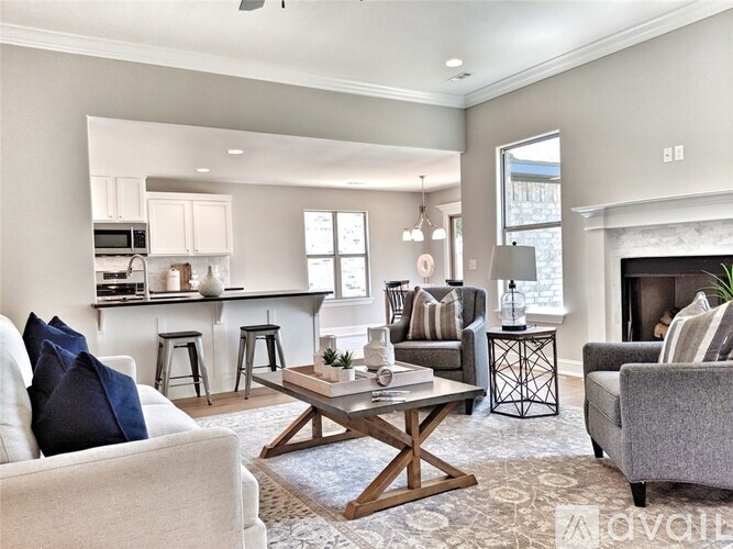 A modern living room with a fireplace and a dining area in the background.