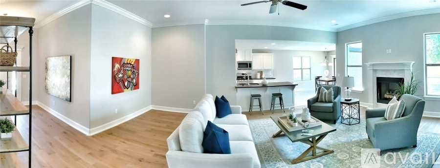 A living room with a white couch and a fireplace.