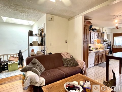 A cat is sitting on a table in a living room.