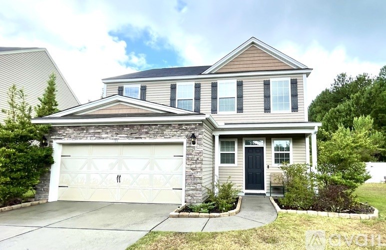A two-story house with a garage door and a front door.