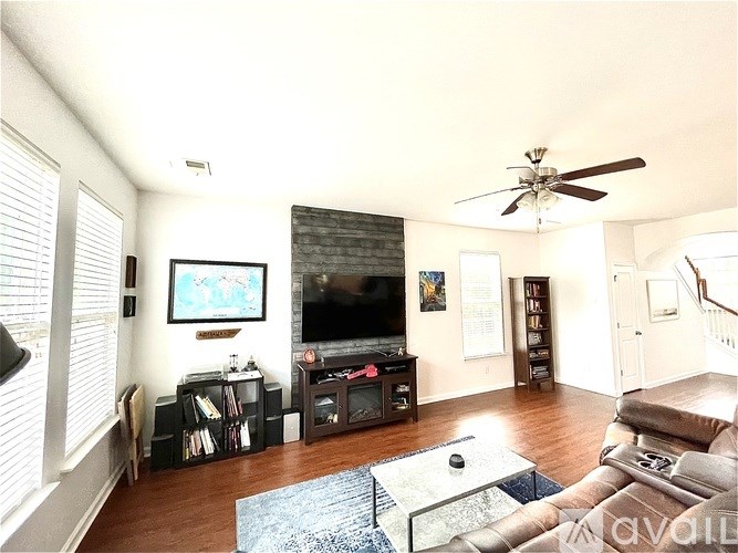 A living room with a television, a couch, and a coffee table.