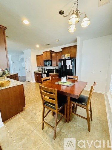 A kitchen with a table and chairs in the foreground.