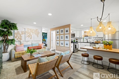 A modern kitchen with a dining table and chairs in the foreground.