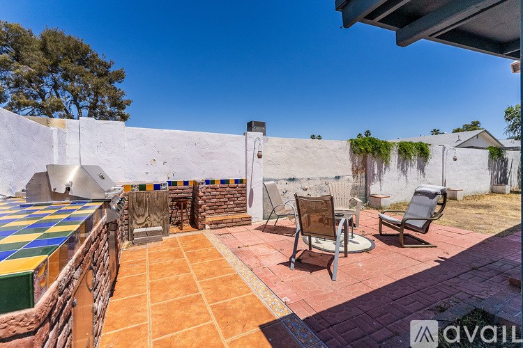 A patio with a table and chairs is available for rent.