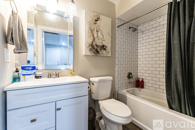 A bathroom with a toilet, sink, and bathtub.