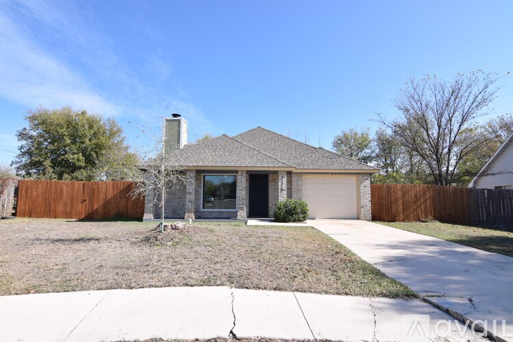 A house with a grey roof and a brown fence.