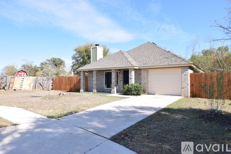 A house with a garage and a driveway in front.