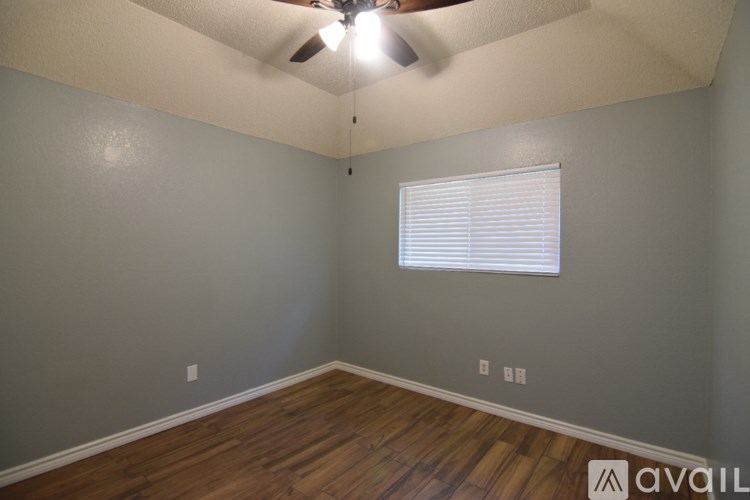 A bathroom with a toilet, sink, and mirror.