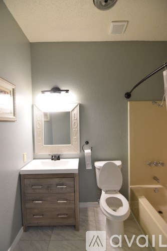 A room with a ceiling fan and wooden flooring.