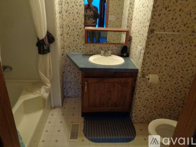 A bathroom with a sink, toilet, and bathtub.