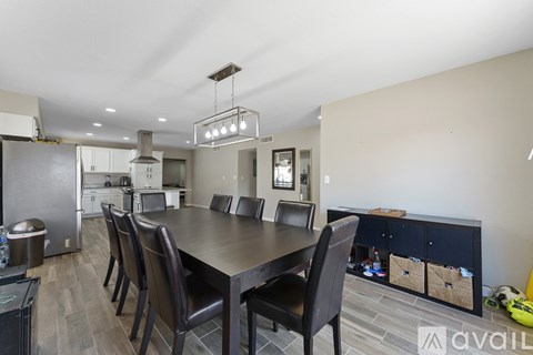 A modern kitchen with a dining table and chairs.
