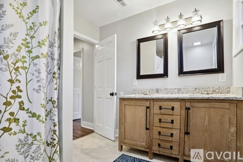 A bathroom with a black and white checkered floor.