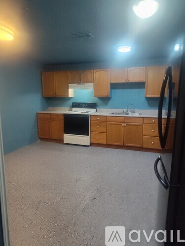 A kitchen with wooden cabinets and a white oven.
