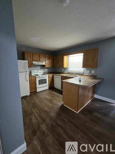 A kitchen with wooden cabinets and a white refrigerator.