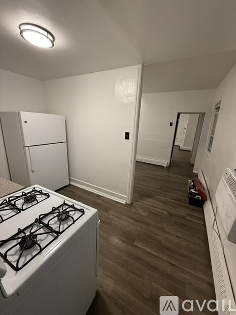 A kitchen with a white stove and a white fridge.