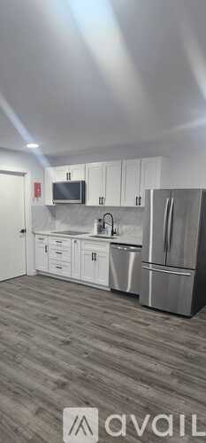 A kitchen with white cabinets and stainless steel appliances.